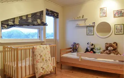 a baby room with a crib and stuffed animals at 5 Bedroom Beach Front Home In Lavik in Lavik