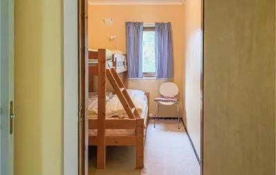 a small room with a bunk bed and a window at Nice Home In Byrkjelo With Kitchen in Byrkjelobrua