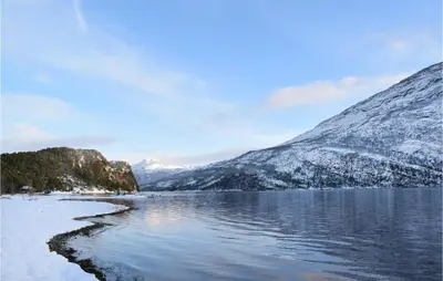 a body of water with snow covered mountains at 3 Bedroom Beautiful Home In Eikefjord in Eikefjord
