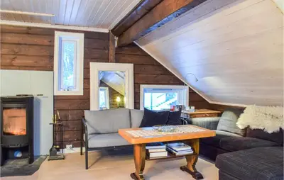 a living room with a couch and a table at 3 Bedroom Beautiful Home In Eikefjord in Eikefjord