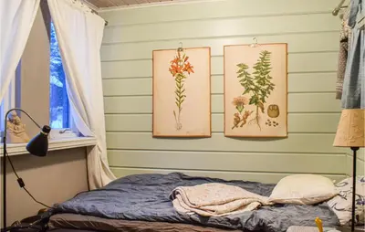 a bedroom with three paintings on the wall at 3 Bedroom Beautiful Home In Eikefjord in Eikefjord