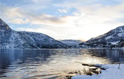 a view of a lake with snow covered mountains at 3 Bedroom Beautiful Home In Eikefjord in Eikefjord