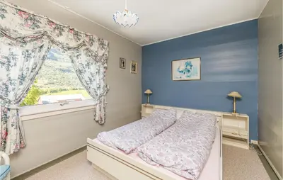 a bedroom with a bed and a window at Awesome Home In Oldedalen in Briksdalsbre