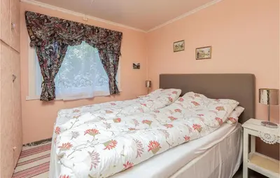 a bed in a bedroom with a window at Awesome Home In Oldedalen in Briksdalsbre