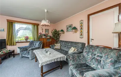 a living room with couches and a table at Awesome Home In Oldedalen in Briksdalsbre