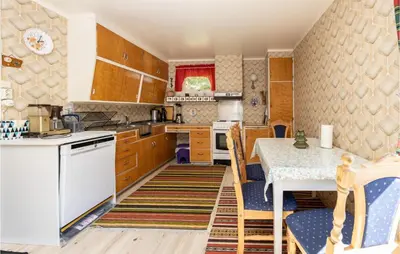 a kitchen with a table and a table and chairs at Awesome Home In Oldedalen in Briksdalsbre