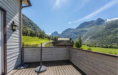 a balcony with a view of mountains at Awesome Home In Oldedalen in Briksdalsbre
