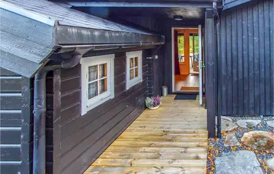 a building with a dog house on the side of it at Cozy Home In Sykkylven With Kitchen in Sykkylven