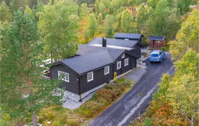 a house with a car parked in front of it at Cozy Home In Sykkylven With Kitchen in Sykkylven