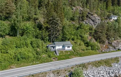 an aerial view of a house on the side of a road at 2 Bedroom Awesome Home In Isfjorden in Isfjorden