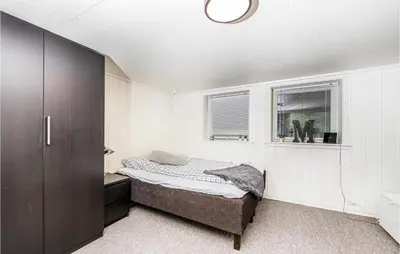 a small bedroom with a bed and a window at Gorgeous Home In Vestnes With Wifi in Vestnes
