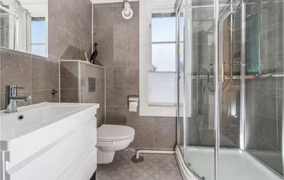 a bathroom with a sink toilet and a shower at 2 Bedroom Stunning Apartment In Åfarnes in Åfarnes