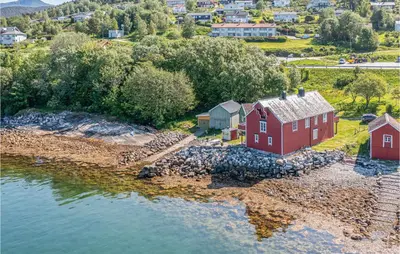 an aerial view of a red house next to the water at 2 Bedroom Stunning Apartment In Åfarnes in Åfarnes