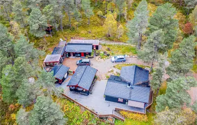 an aerial view of a house with cars parked in front at 2 Bedroom Cozy Home In Øydegard in Nastad