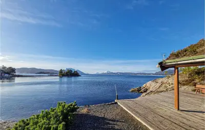 a view of a lake with a wooden dock at 3 Bedroom Beautiful Home In Øydegard in Aspa