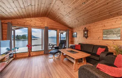 a living room with a couch and a table at 3 Bedroom Beautiful Home In Øydegard in Aspa