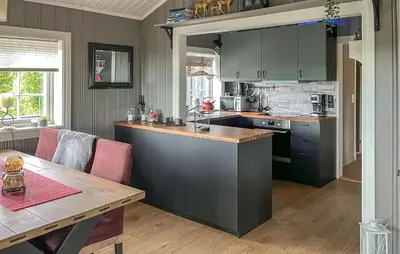 a kitchen with green cabinets and a wooden table at Pet Friendly Home In Rena With Wifi in Rena