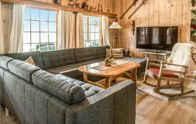 a living room with a couch and a table at 3 Bedroom Lovely Home In Tynset in Tynset