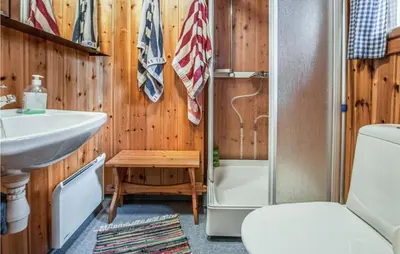 a bathroom with a toilet and a sink and a shower at 3 Bedroom Lovely Home In Tynset in Tynset