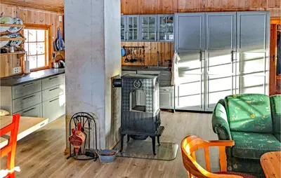 a kitchen with a stove and a refrigerator at 3 Bedroom Lovely Home In Tynset in Tynset