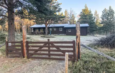 a wooden fence in front of a barn at 3 Bedroom Lovely Home In Tynset in Tynset
