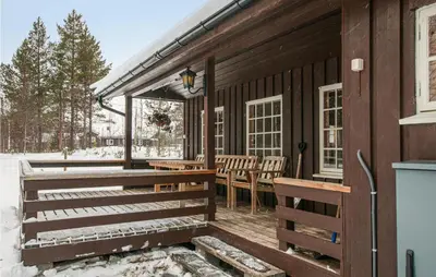 a porch of a wooden house with snow on it at 3 Bedroom Lovely Home In Tynset in Tynset