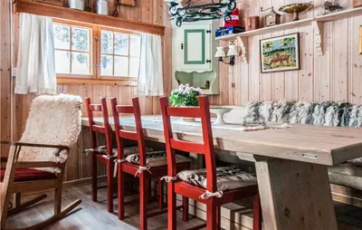 a dining room with a wooden table and chairs at 3 Bedroom Lovely Home In Tynset in Tynset
