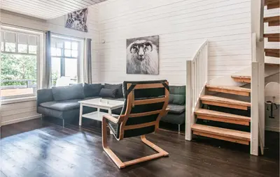 a living room with a couch and a chair at Gorgeous Home In Søre Osen With Wifi in Midskogberget