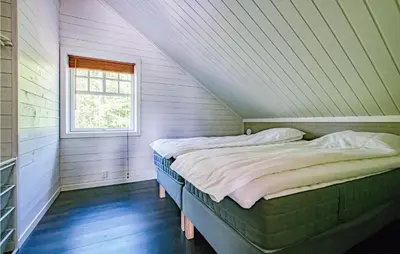 a bedroom with a bed in a attic with a window at Gorgeous Home In Søre Osen With Wifi in Midskogberget