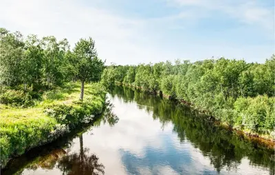 a river with trees on both sides of it at Amazing Home In Tufsingdalen With Wifi in Bakken