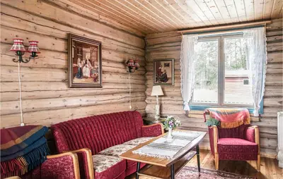 a living room with wooden walls and a table and chairs at Amazing Home In Tufsingdalen With Wifi in Bakken