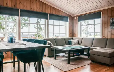 a living room with a couch and a table at Beautiful Home In Engerdal With Kitchen in Kvisla