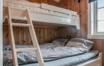 a bunk bed with a ladder in a room at Beautiful Home In Engerdal With Kitchen in Kvisla