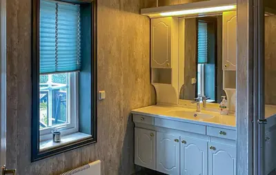 a bathroom with a sink and a mirror and a window at Lovely Home In Trysil With Wifi in Trysil