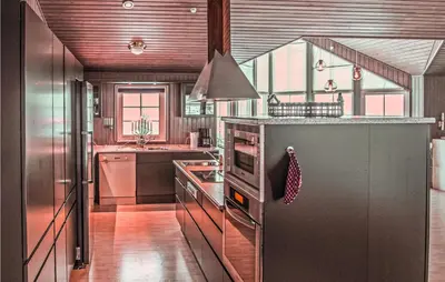 a kitchen with stainless steel appliances and a stove top oven at Lovely Home In Trysil With Wifi in Trysil