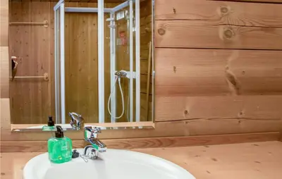 a bathroom with a white sink and a mirror at Lovely Home In Drevsjø With Lake View in Drevsjø