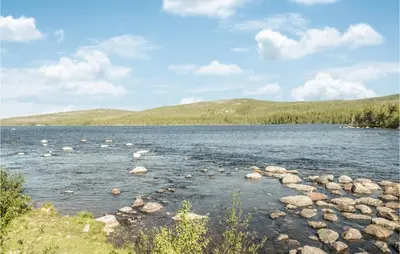 a large body of water with rocks in it at Lovely Home In Drevsjø With Lake View in Drevsjø
