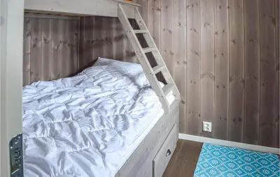 a bedroom with a bunk bed with a ladder at 3 Bedroom Amazing Home In Jaren in Jaren