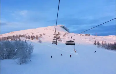 a group of people riding a ski lift in the snow at 3 Bedroom Awesome Home In Svingvoll in Svingvoll