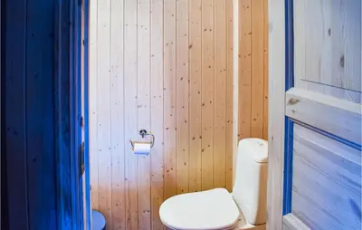 a bathroom with a toilet and a toilet paper dispenser at 10 Bedroom Lovely Home In Østre Gausdal in Vestre Gausdal