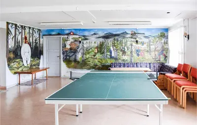 a ping pong table in a room with a mural at 10 Bedroom Lovely Home In Østre Gausdal in Vestre Gausdal