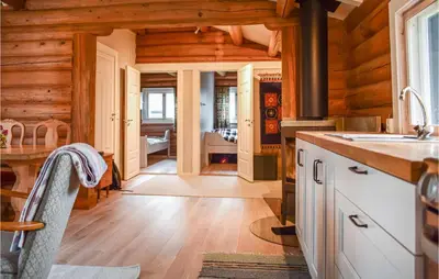 a kitchen with wooden walls and wooden flooring at Nice Home In Kvam With Kitchen in Kvam