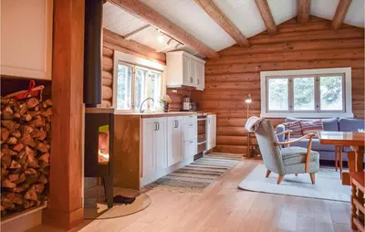 a kitchen and living room in a log cabin at Nice Home In Kvam With Kitchen in Kvam