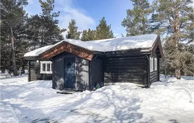 a small cabin with snow on top of it at Nice Home In Kvam With Kitchen in Kvam