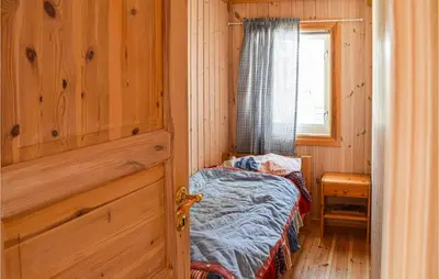 a small room with a small bed and a window at 4 Bedroom Stunning Home In Vinstra in Vinstra