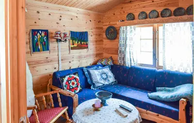 a living room with a blue couch and a table at 4 Bedroom Stunning Home In Vinstra in Vinstra