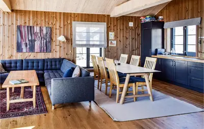 a living room with a blue couch and a table at 4 Bedroom Beautiful Home In Øyer in Øyer