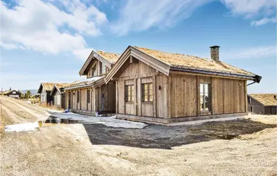 a wooden house on the side of a dirt road at 4 Bedroom Beautiful Home In Øyer in Øyer