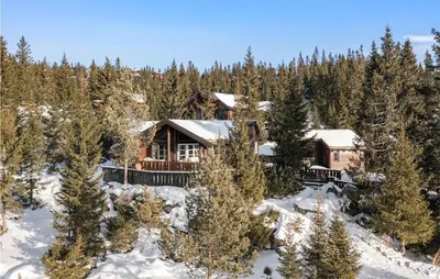 a log cabin in the woods in the snow at Gorgeous Home In Øyer With Sauna in Øyer
