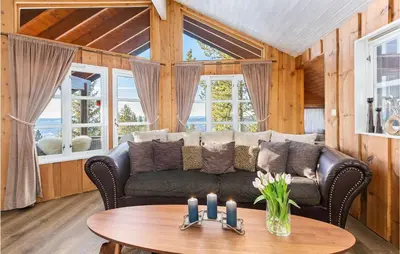 a living room with a couch and a table at Gorgeous Home In Øyer With Sauna in Øyer
